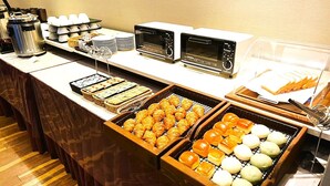 A buffet with various baked goods, including croissants and bread rolls, and multiple coffee machines. - Hotel IL Cuore Namba (Osaka)