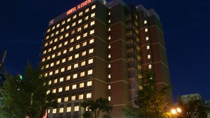 A multi-story hotel with a prominent sign at the top. - Hotel IL Cuore Namba (Osaka)