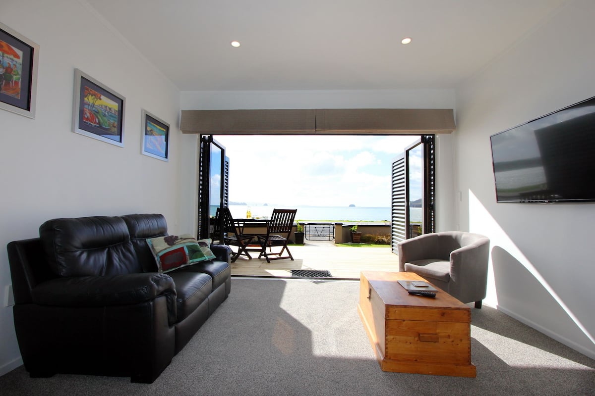 2 - Supreme Beachfront Studio Apartment | Living area | Flat-screen TV