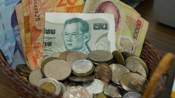 A basket containing various currencies and coins.
