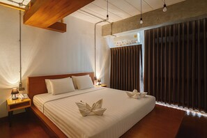 A hotel room with a large bed, wooden headboard, bedside tables with lamps, and a window with curtains. - The Loft Room Nimman (Chiang Mai)