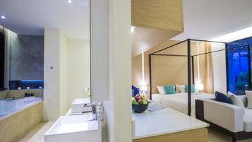 Relax in a spacious room with a large bathtub, separate shower, and cozy seating area.