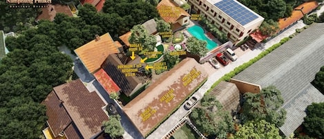An aerial view of Namphung Phuket Boutique Resort with a Deluxe Two Bedroom Pool View Villa, a Duplex Apartment Wing, and various budget and premium rooms.