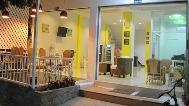 A modern interior with a seating area, a staircase, and a reception desk.