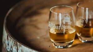 Two glasses of Bullardine whisky on a wooden surface. - Middleton House (Auchterarder)