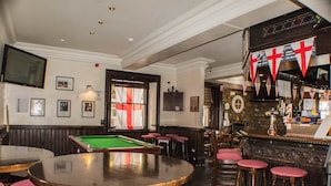 A billiards table, bar area, and seating with stools. - The Royal Oak Hotel (York)