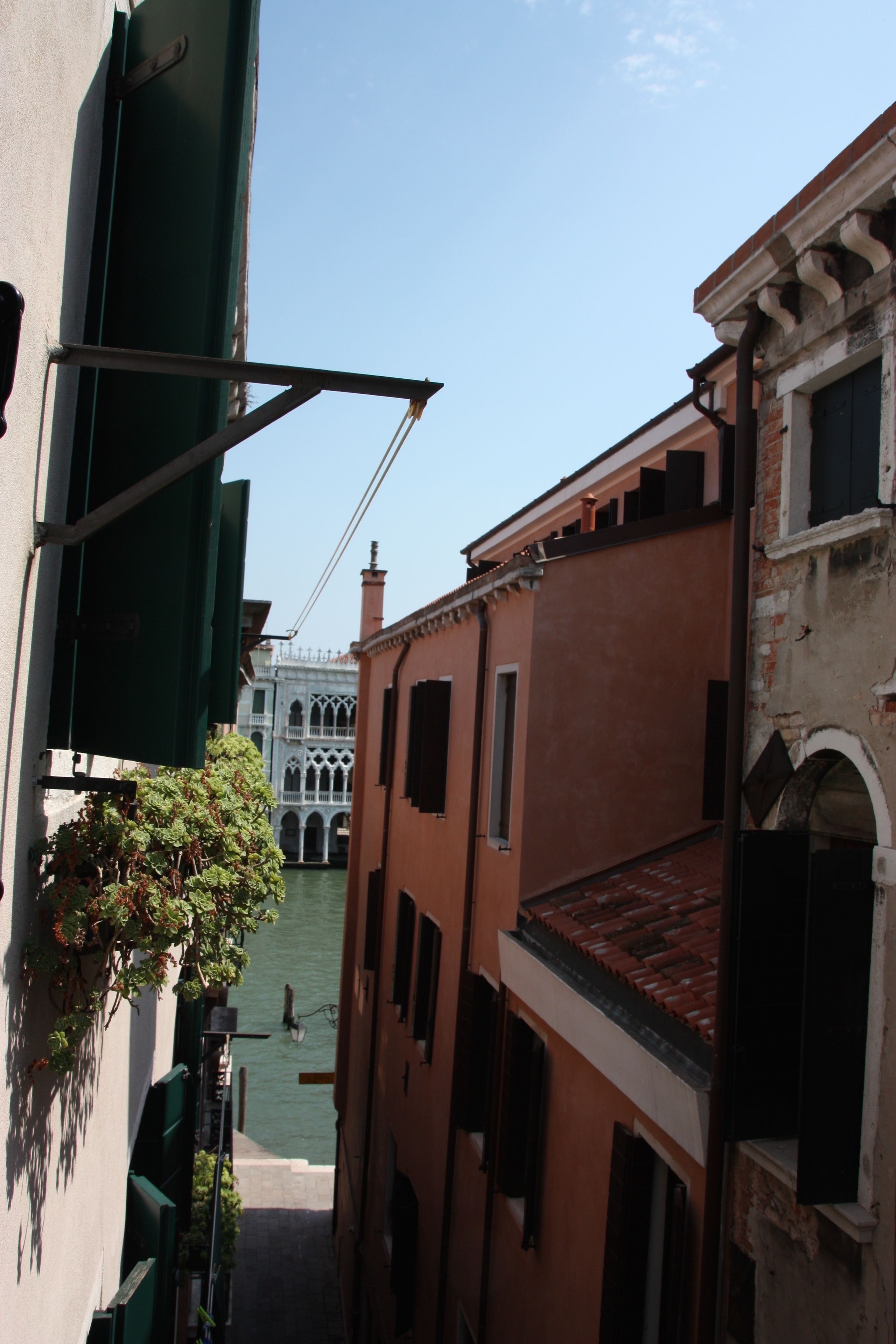 A narrow Venetian canal with buildings on either side.