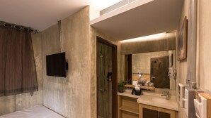 A modern bathroom with a shower, a sink, and a mirror.