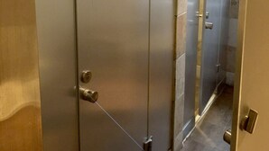 A row of metallic, frosted doors in a hallway, likely leading to private rooms or suites. - 365 inn - Hostel (Beijing)