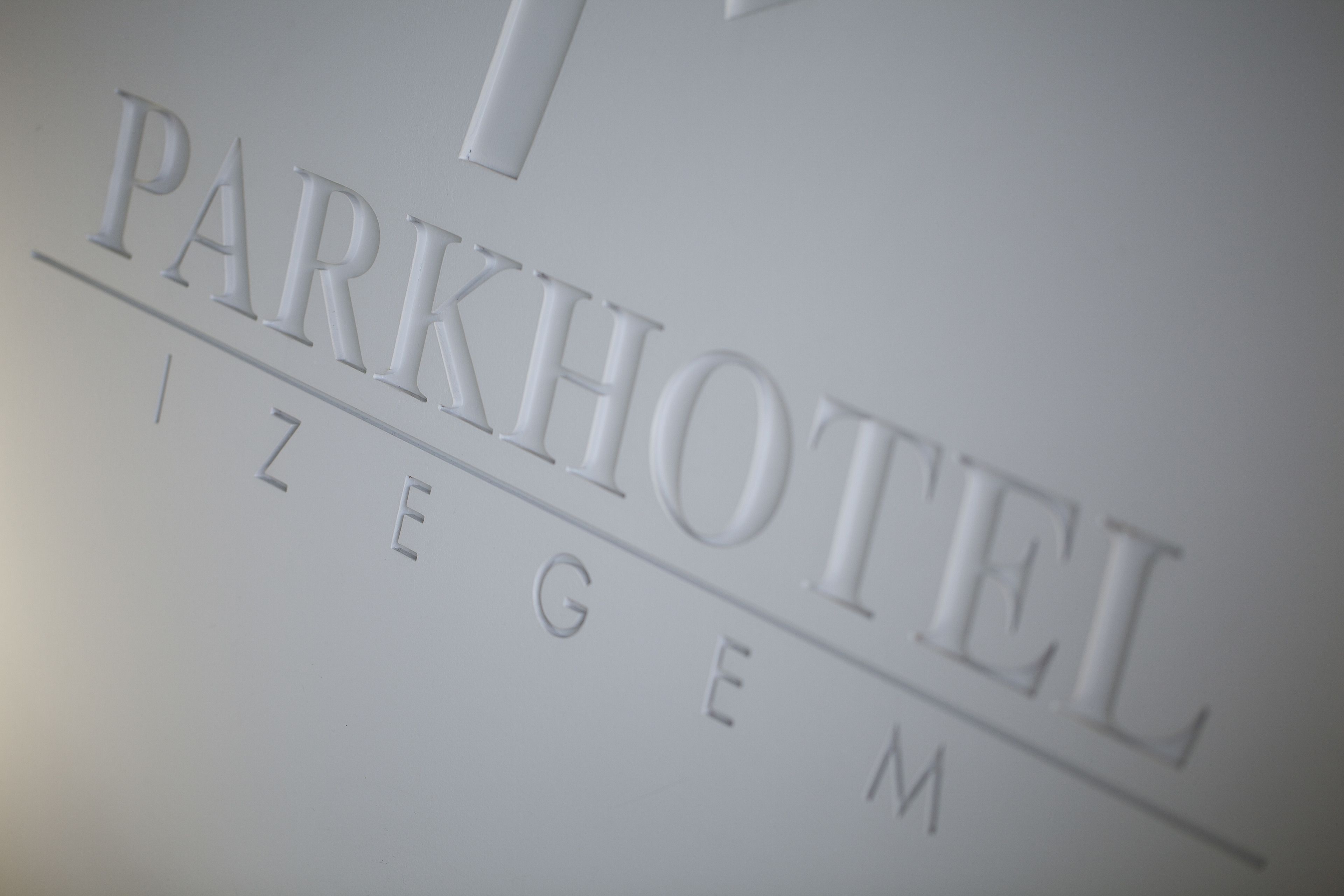 Una señal con el texto 'PARKHOTEL IZEGE' que indica el nombre del hotel.