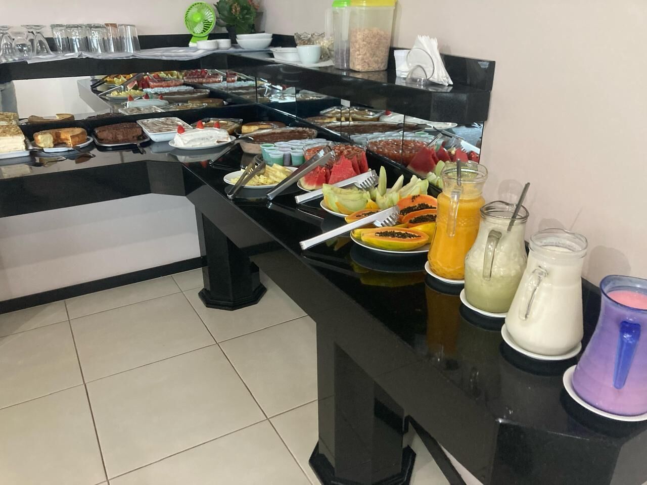 A buffet with various food items and beverages.