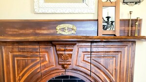 A fireplace with a decorative mantel and a plaque above it. - Fisherman's Daughter Bed & Breakfast (Mahone Bay)