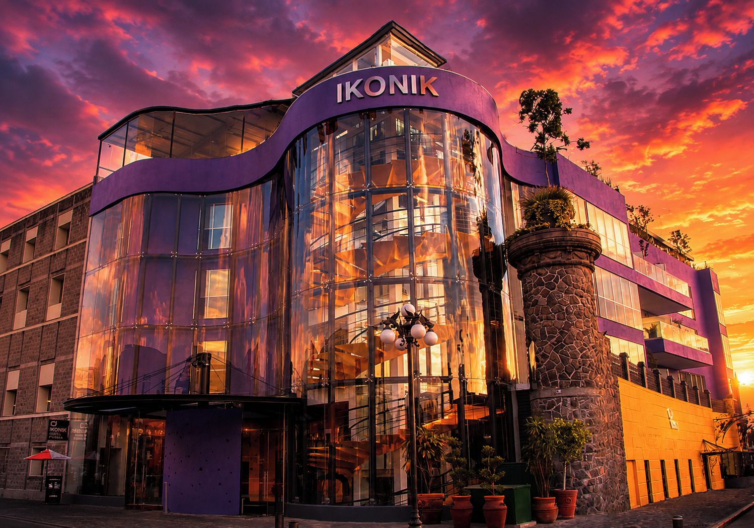 A modern building with the name 'IKONIK' prominently displayed.