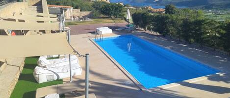 Outdoor pool, pool umbrellas, sun loungers