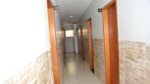A hallway with multiple doors, each marked with a number. - Hotel Cerrado (Goiania)