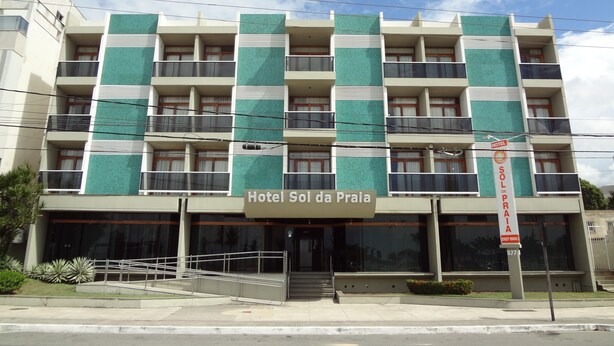 A multi-story hotel with a modern design, featuring balconies on each floor and a prominent entrance with a staircase. - Hotel Sol da Praia (Vitoria)