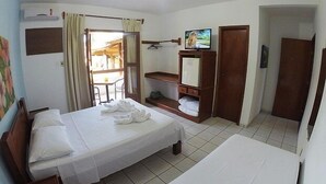 A hotel room with a bed, a TV, a small fridge, and a door leading to a balcony. - Sesc Bonito (Bonito)