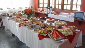 A buffet table with various food items and a coffee station. - Sesc Bonito (Bonito)