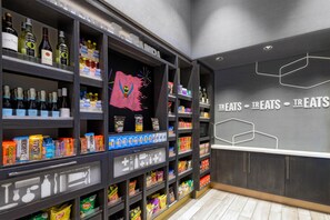 A store interior with shelves stocked with snacks, beverages, and personal care items. - Hampton Inn & Suites Tampa Airport Avion Park Westshore (Tampa)