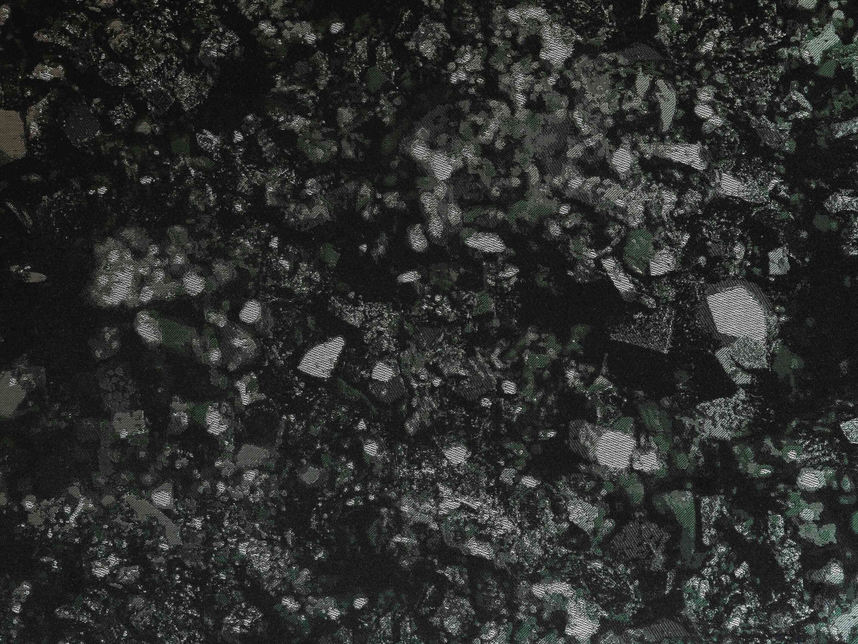 A textured surface with a pattern of irregular shapes and lines.