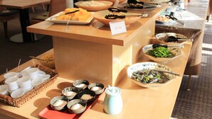 A buffet setup with various dishes and utensils. - Breezbay Shuzenji Hotel (Izu)