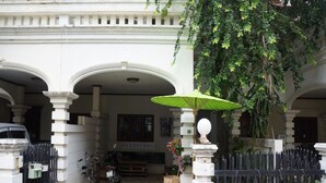 A traditional building with a central courtyard, a bicycle parked outside, and a sign that reads "SLEEPYOHO". - Sleepy Oho (Chiang Mai)