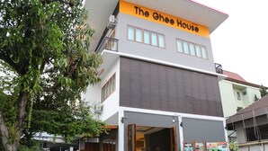 A two-story building with a sign reading "The Ghee House." - The Ghee House (Chiang Mai)