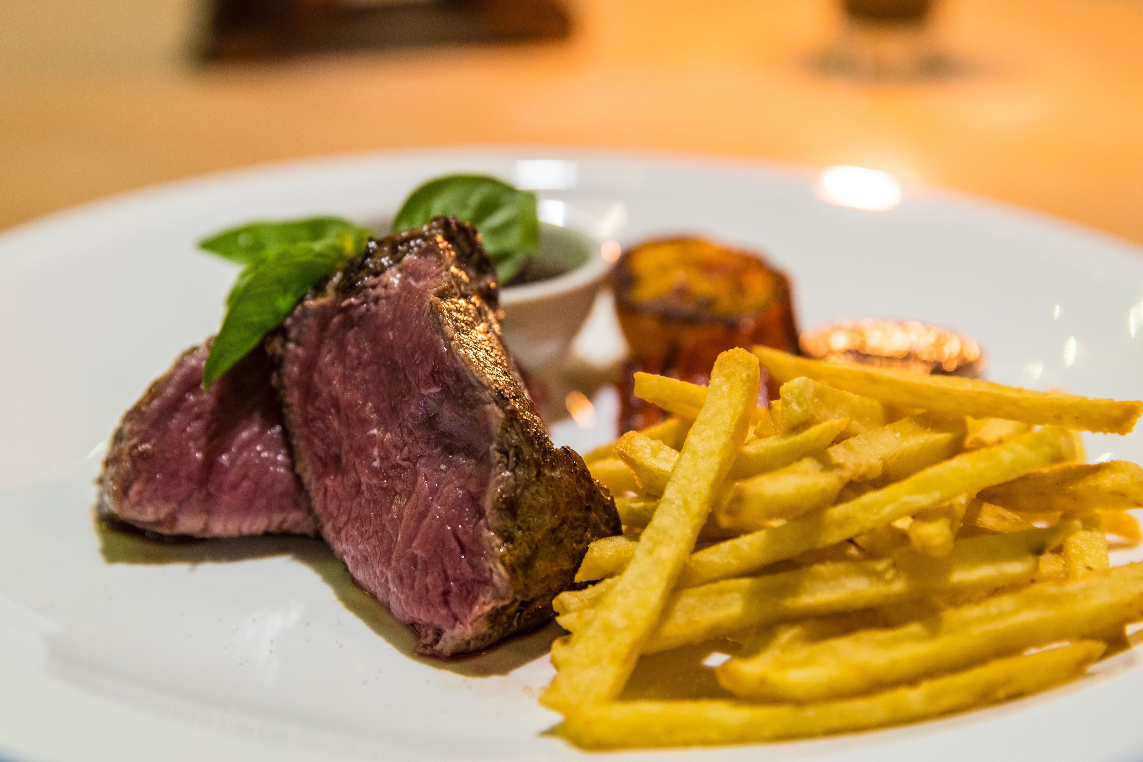 A plate with steak and fries.