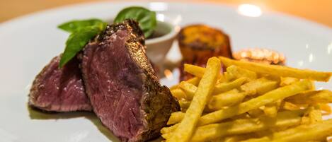A plate with steak and fries.