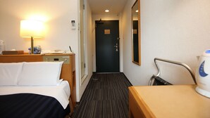 A hotel room with a bed, bedside table, lamp, and a desk with a chair. - Kyoto Plaza Hotel (Kyoto)