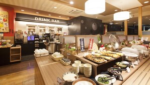 A buffet area with a drink bar in the background.