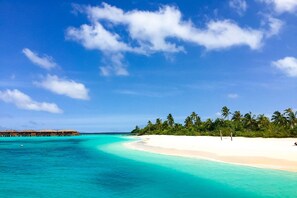 Private beach, white sand, beach umbrellas, scuba diving