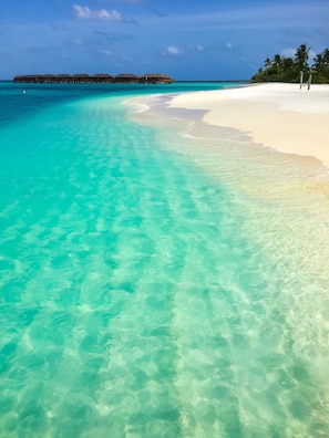 Private beach, white sand, beach umbrellas, scuba diving