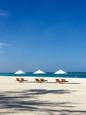Private beach, white sand, beach umbrellas, scuba diving