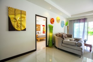 Executive Villa | Living room | 32-inch flat-screen TV with cable channels, TV, DVD player
