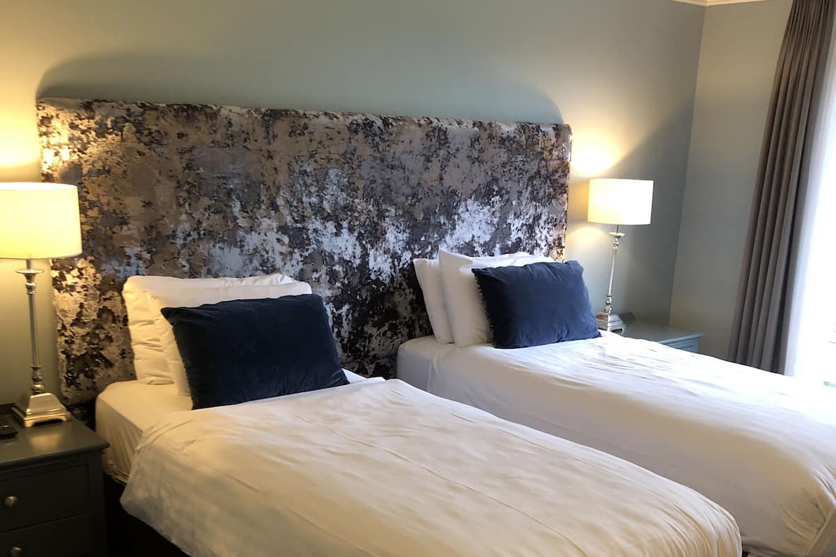 classic twin room | 1 bedroom, desk, laptop workspace, iron/ironing board