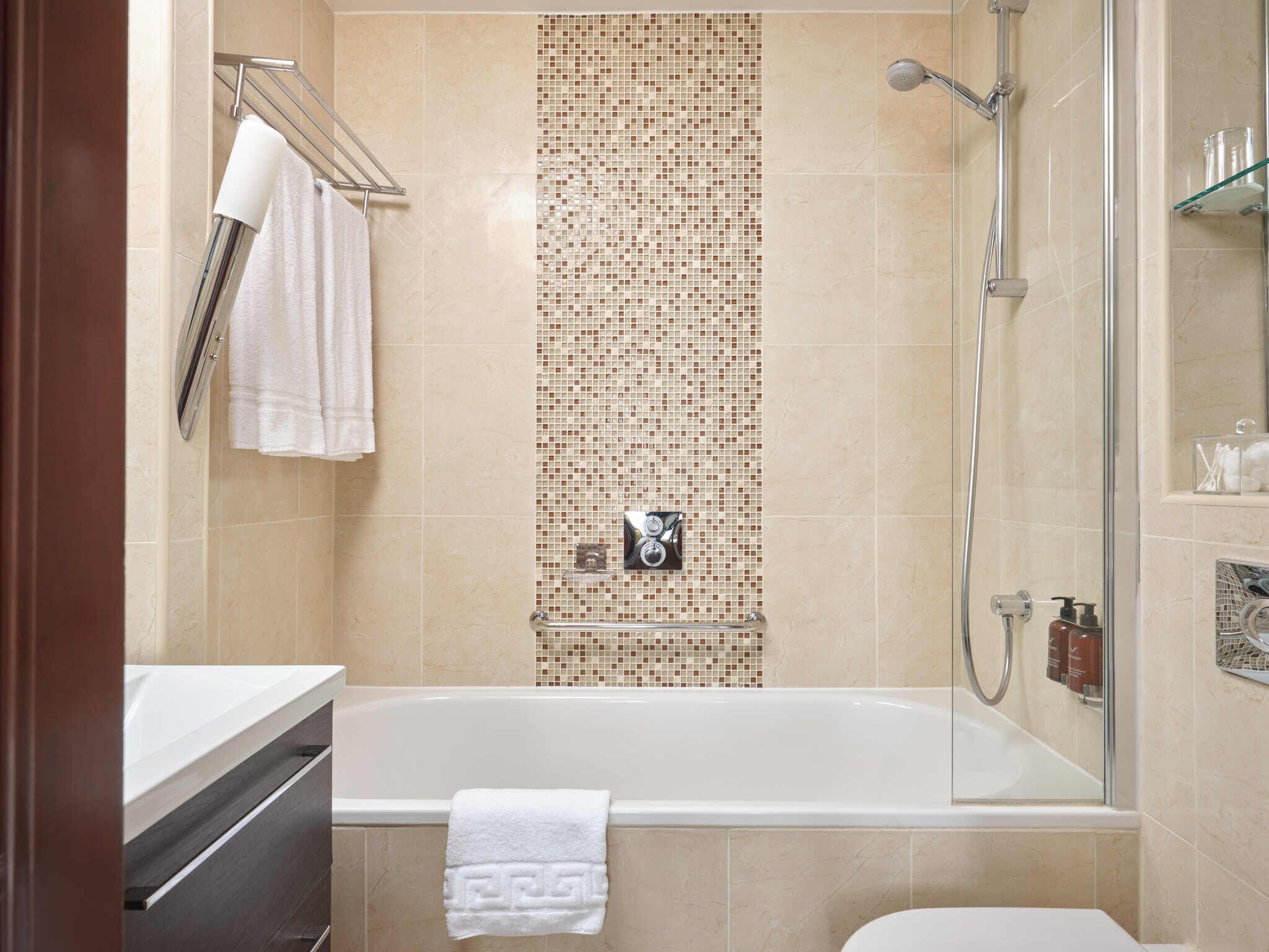 bathtub, free toiletries, hair dryer, towels