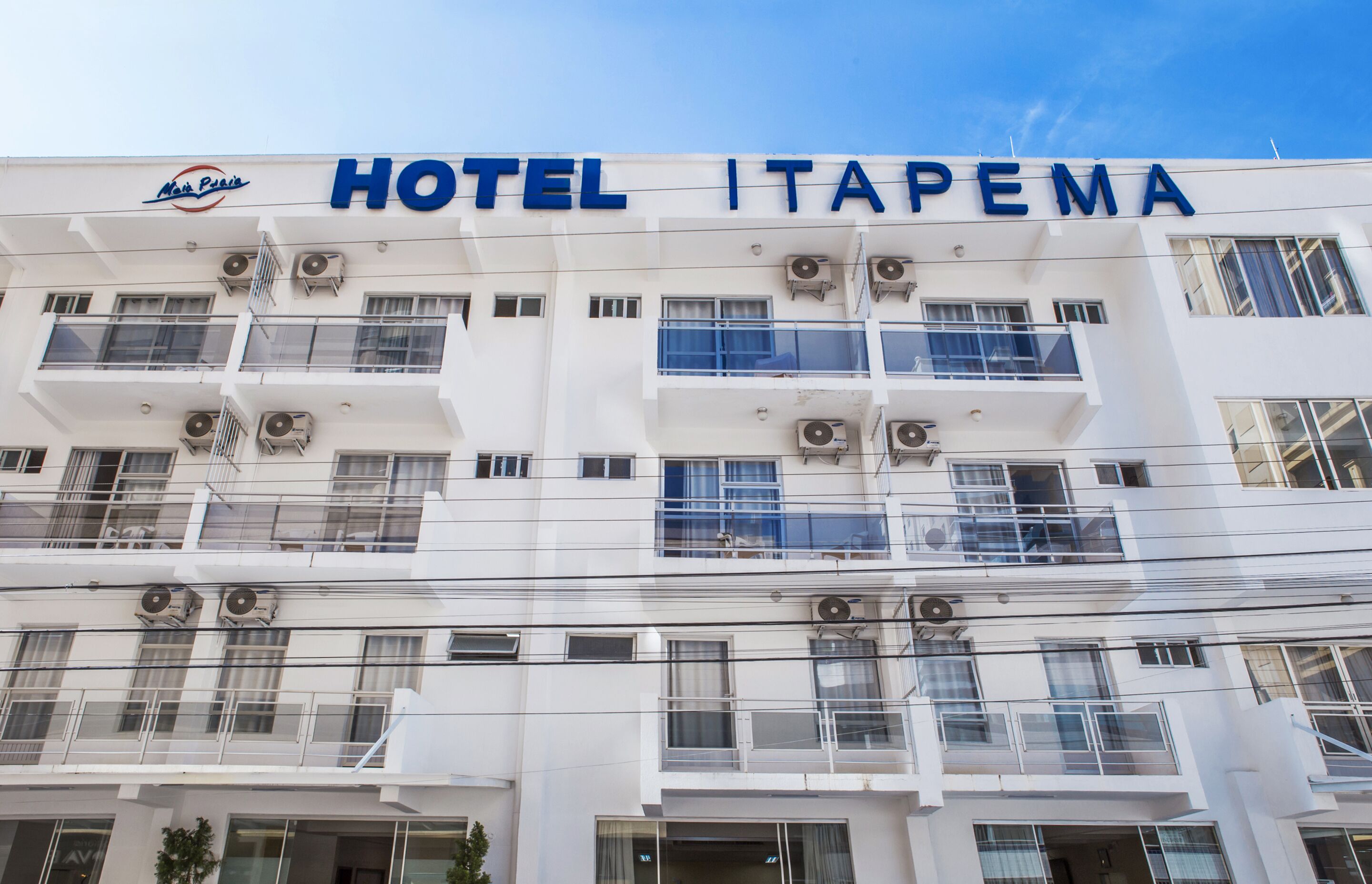 A multi-story building with balconies and air conditioning units, labeled "HOTEL ITAPEMA."