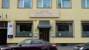 A building with a sign for Restaurant Valley Rose, indicating it offers Wiener Küche, Pizza, and Pasta.