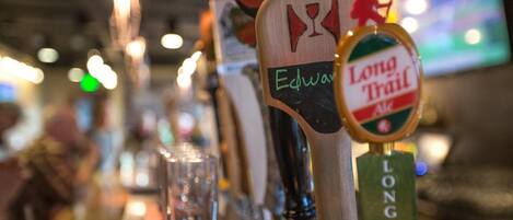 Eine Bar mit mehreren Zapfhähnen, darunter einer mit der Aufschrift 'Edward' und ein anderer mit 'Long Trail'.