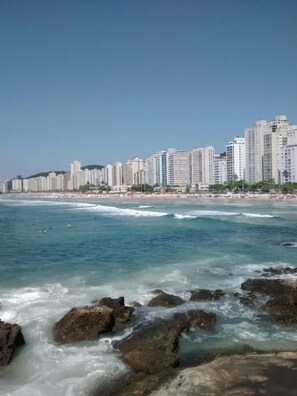 Stunning coastal cityscape with high-rise buildings and a serene beach.