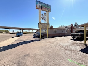 A motel with a sign advertising free coffee, kitchen, and WiFi.