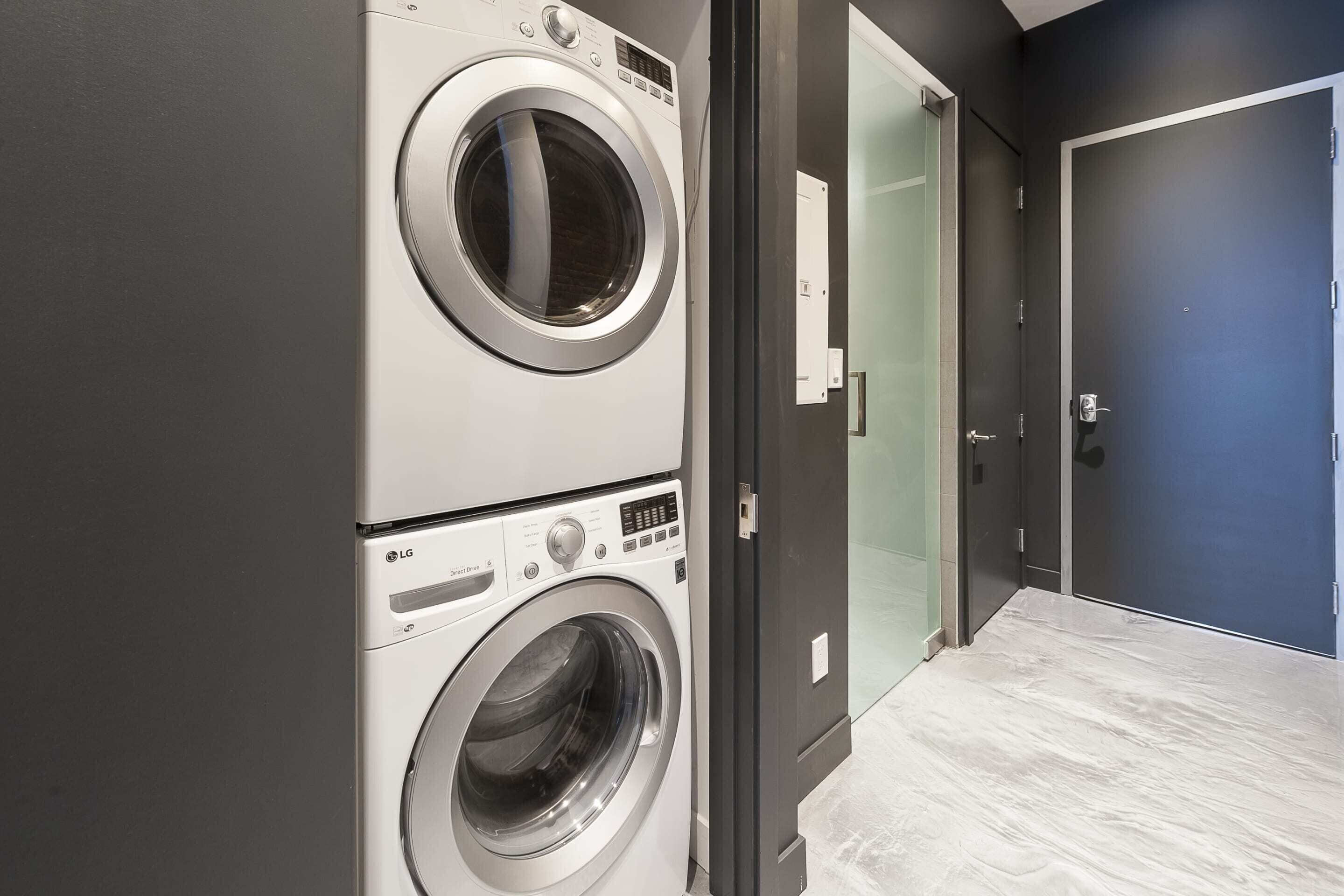 A laundry room with two stacked front-loading washing machines.