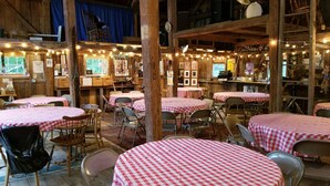 A rustic dining area with checkered tablecloths, wooden tables, and chairs. - The Farmstand Bed & Breakfast (Chocorua)