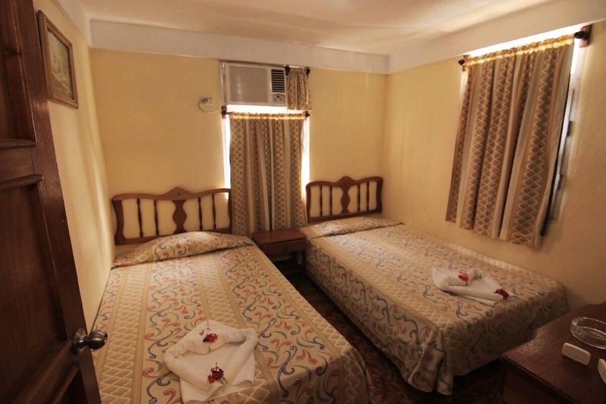 Desk, laptop workspace, blackout drapes, bed sheets