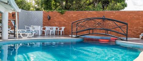 Outdoor pool, open 8:00 AM to 10:00 PM, pool loungers