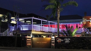 A bar and venue with a covered outdoor area, a sign for 'Shooter's Bar & Venue', and a 'Hotel, Bar & Function Venue' sign. - Shooters Saloon Bar Hotel & Cabins (Auckland)
