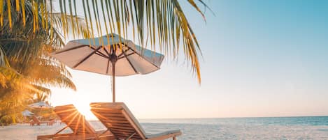 Private beach, white sand, beach cabanas, beach umbrellas