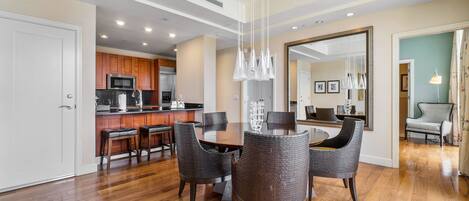 A modern kitchen with wooden cabinets, a stainless steel refrigerator, and a built-in microwave.