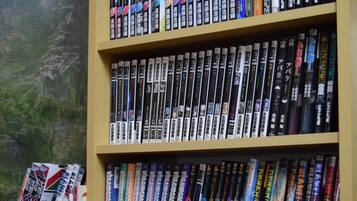A bookshelf filled with various books and DVDs.